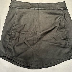 Charlotte Russe. Black pleather skirt with zipper back and asymmetrical hem Sz M